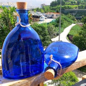 بطری آبی نیم لیتری با درب چوب پنبه پرتقالی نیم طرح کتابی