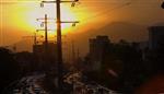 فوتیج تایم لپس غروب خورشید بر فراز کوه های تهران و ترافیک تردد در بزرگراه