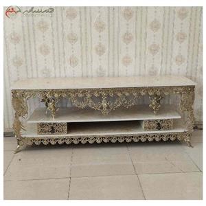 میز تلویزیون برنزی چهار کشو با رویه هایگلس و طراحی دو طبقه با پایه های فرشته