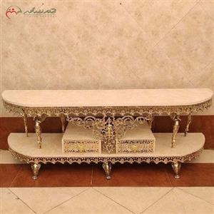 میز تلویزیون برنزی طرح نیم گرد همراه دو عدد کشوی طراحی شده با پایه های طرح فرشته