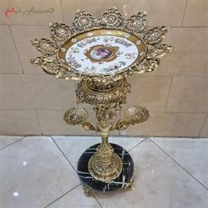 میوه خوری کنار سالنی با بدنه ی تمام برنزی و رنگ طلایی طرح دار، زیبا و با کیفیت 